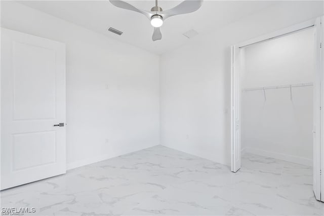 unfurnished bedroom featuring ceiling fan, marble finish floor, a closet, and visible vents