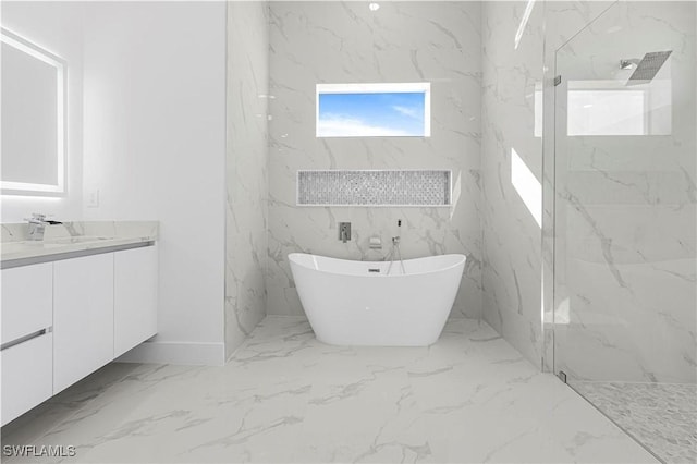 full bath with a freestanding tub, a marble finish shower, marble finish floor, and vanity