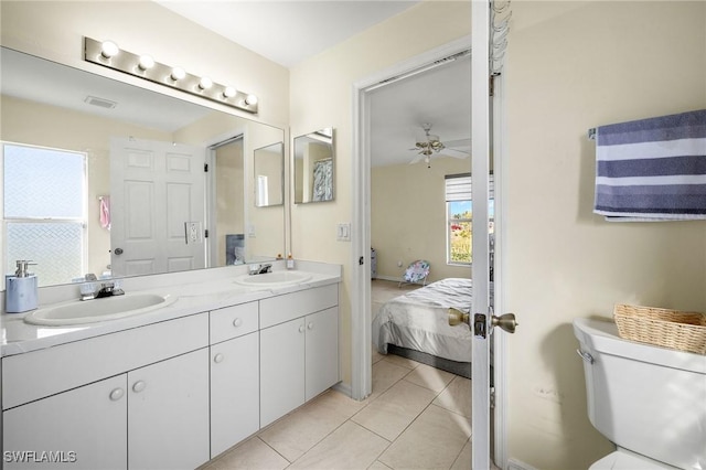 bathroom featuring double vanity, a sink, visible vents, and tile patterned floors