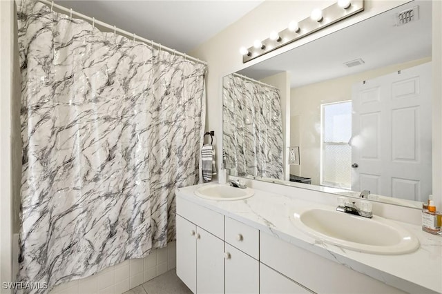 full bathroom featuring double vanity, a sink, and visible vents