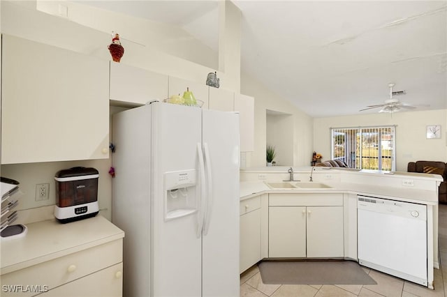 kitchen with a peninsula, white appliances, a sink, open floor plan, and light countertops