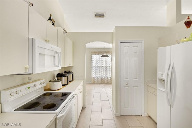 kitchen with light tile patterned floors, light countertops, visible vents, white cabinetry, and white appliances