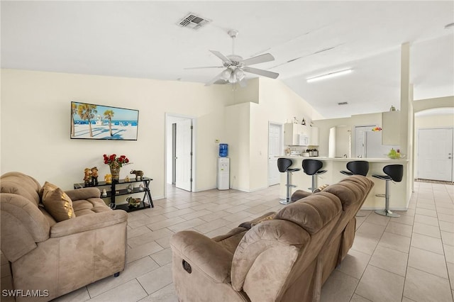 living room with lofted ceiling, light tile patterned floors, ceiling fan, and visible vents