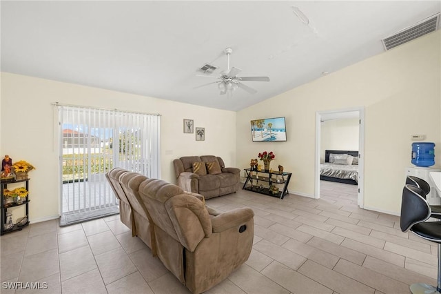 living room featuring lofted ceiling, light tile patterned floors, ceiling fan, and visible vents