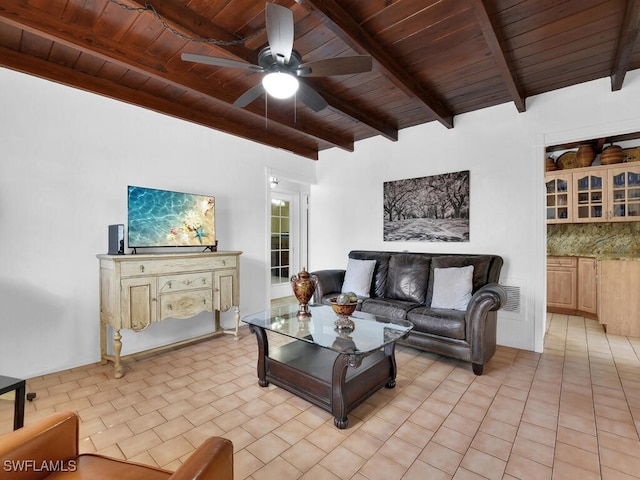 living area featuring wood ceiling, ceiling fan, beam ceiling, and light tile patterned flooring