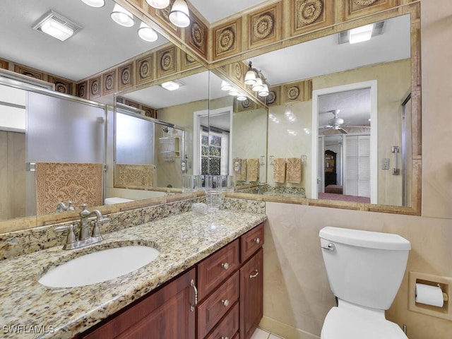 full bath with visible vents, toilet, ceiling fan, a shower stall, and vanity