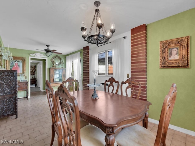 dining room with light tile patterned flooring, baseboards, and ceiling fan with notable chandelier