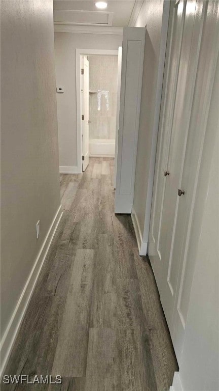 hallway with wood finished floors and baseboards