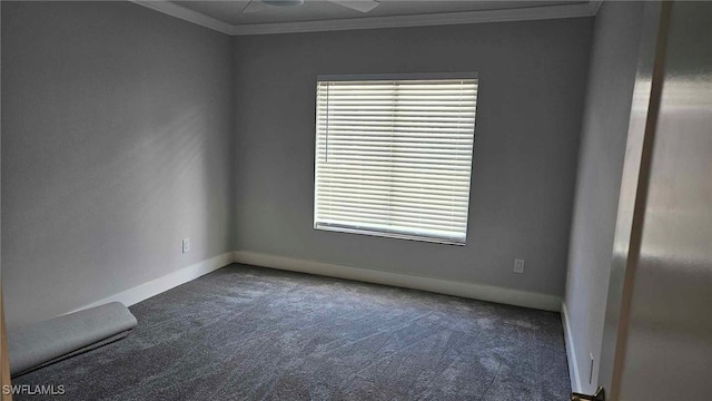 carpeted empty room featuring a ceiling fan, baseboards, and ornamental molding