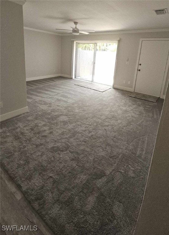 spare room with baseboards, crown molding, a ceiling fan, and carpet floors