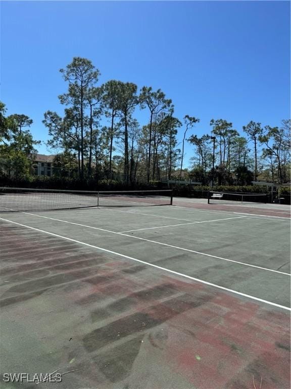 view of tennis court with community basketball court