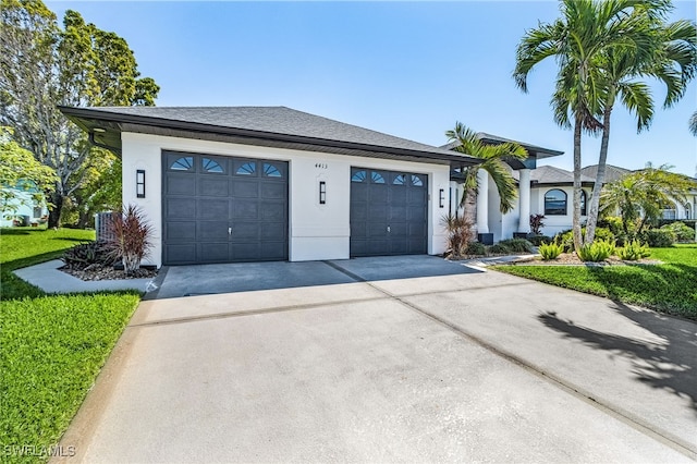 view of front of property featuring concrete driveway and stucco siding