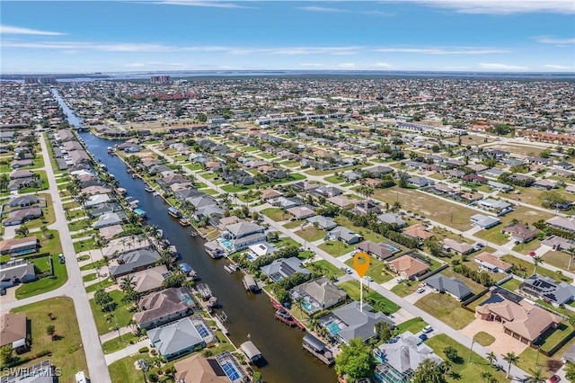 birds eye view of property with a residential view and a water view