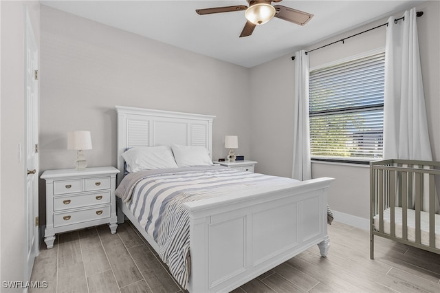 bedroom featuring wood finish floors, baseboards, and ceiling fan