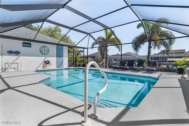 outdoor pool with a lanai and a patio area