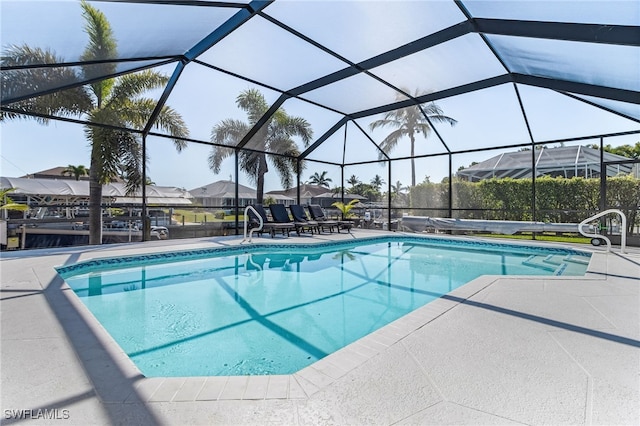 outdoor pool with a lanai and a patio area