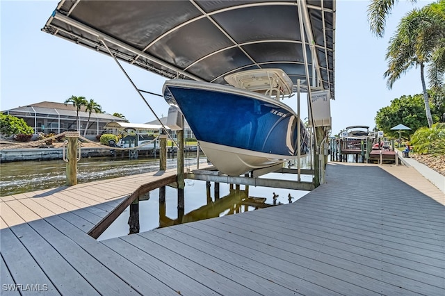 view of dock featuring boat lift and a water view