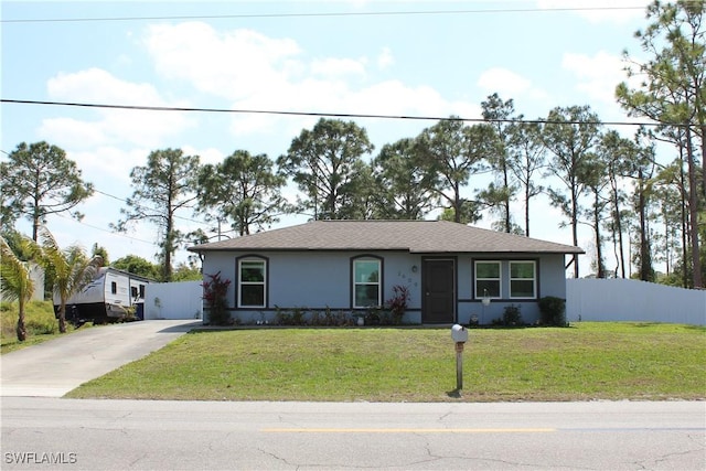 ranch-style home with stucco siding, driveway, a front yard, and fence