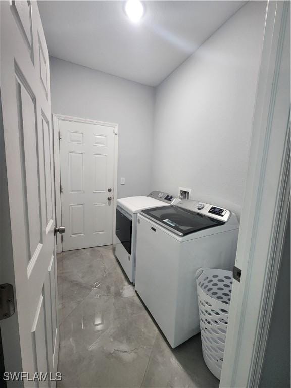 laundry room with laundry area and washing machine and clothes dryer