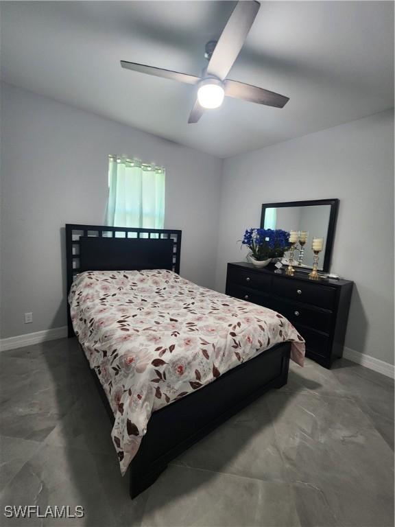 bedroom featuring ceiling fan and baseboards