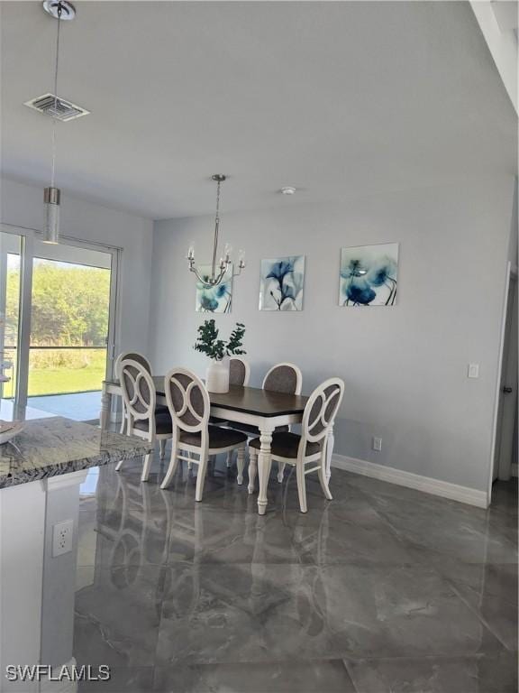 dining space featuring baseboards, visible vents, marble finish floor, and a chandelier