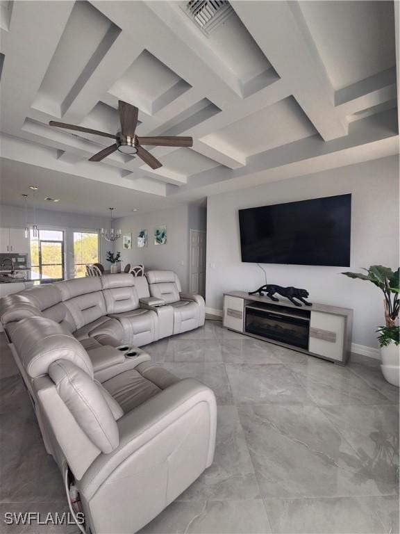 living room featuring marble finish floor, ceiling fan with notable chandelier, visible vents, and coffered ceiling