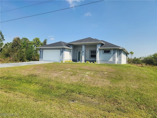 view of front of property with a garage, a front lawn, driveway, and stucco siding