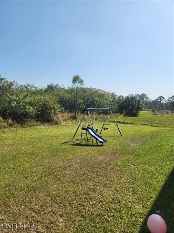 view of jungle gym featuring a lawn