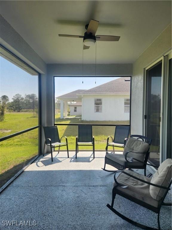 sunroom with a ceiling fan