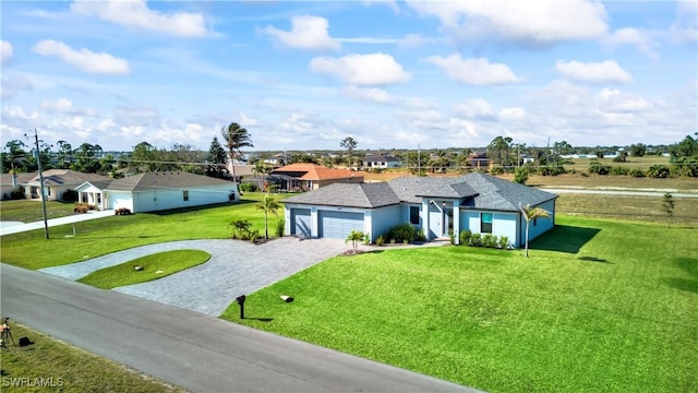 single story home with a garage, decorative driveway, a residential view, and a front yard