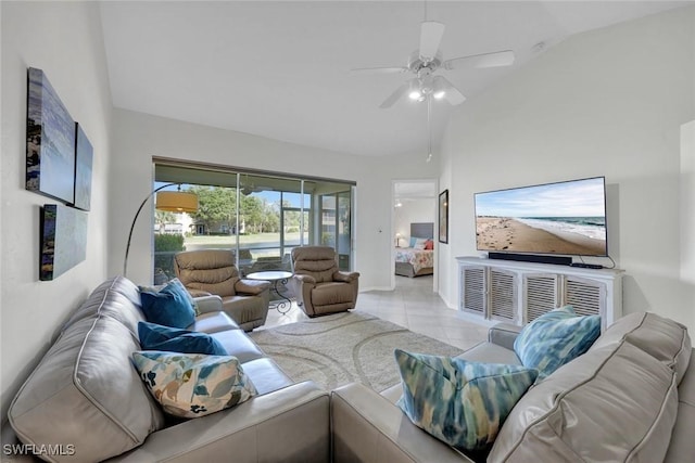 tiled living area featuring a ceiling fan, high vaulted ceiling, and baseboards