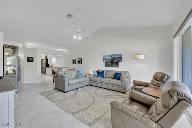 living room featuring lofted ceiling, ceiling fan, light tile patterned flooring, and visible vents