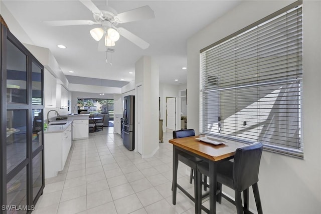 dining space with a ceiling fan, recessed lighting, baseboards, and light tile patterned floors