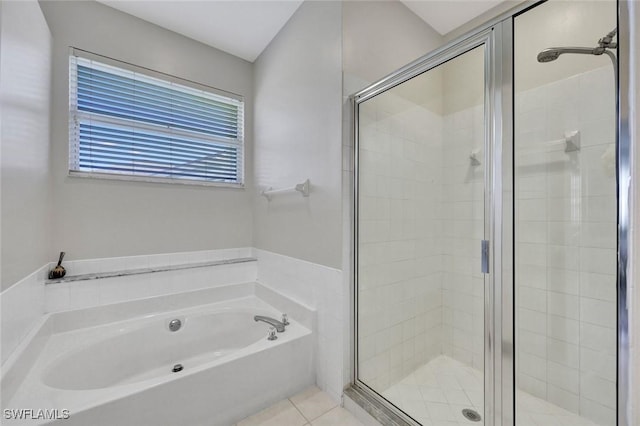 full bathroom featuring a stall shower, a bath, and tile patterned floors