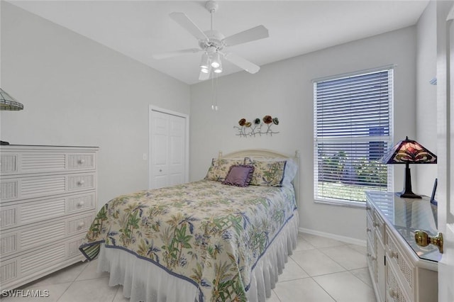 bedroom with ceiling fan, light tile patterned flooring, and baseboards