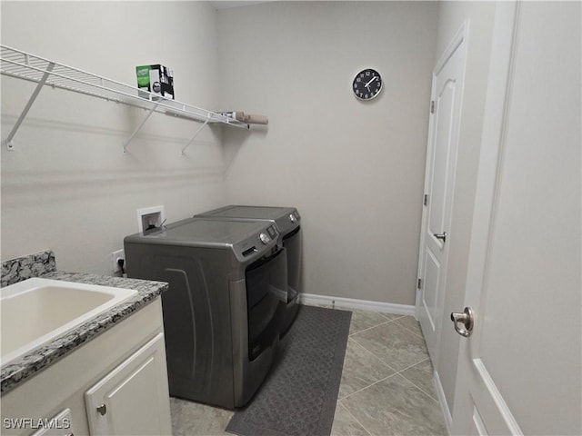 laundry room featuring washer and dryer, a sink, light tile patterned floors, baseboards, and laundry area