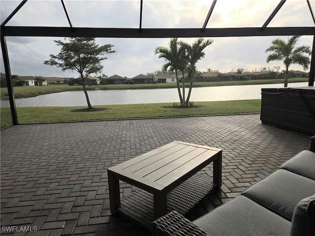 view of home's community with a yard, a patio, and a water view