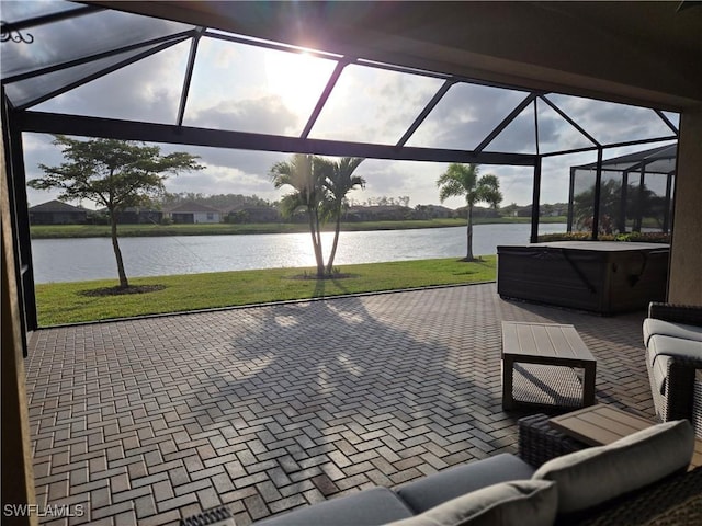 view of patio with glass enclosure, an outdoor living space, a water view, and a hot tub