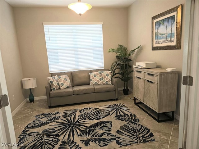 living room featuring light tile patterned floors and baseboards