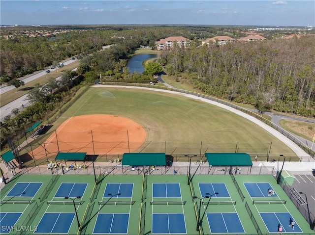 birds eye view of property featuring a water view and a view of trees