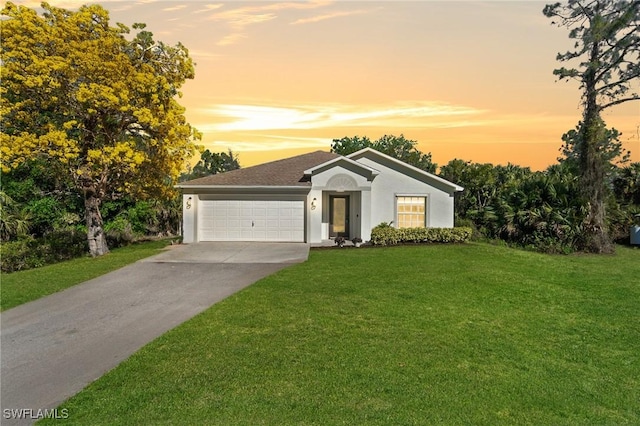 single story home featuring a garage, stucco siding, concrete driveway, and a front lawn