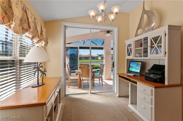 office with vaulted ceiling, a notable chandelier, and built in desk