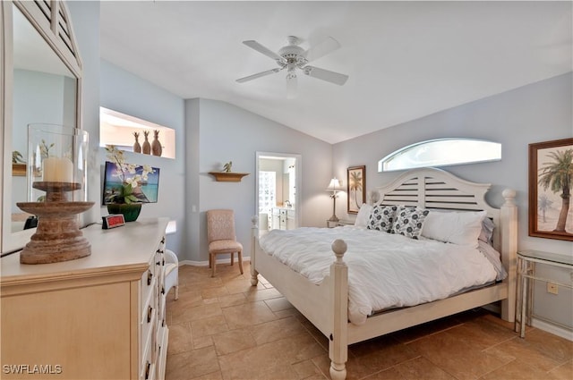 bedroom featuring connected bathroom, stone finish flooring, ceiling fan, baseboards, and vaulted ceiling