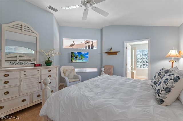 tiled bedroom featuring lofted ceiling, a ceiling fan, visible vents, and ensuite bathroom