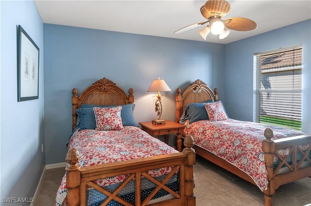 bedroom with tile patterned floors, baseboards, and ceiling fan