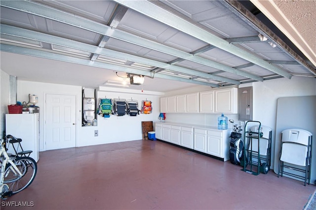 garage featuring electric panel and a garage door opener