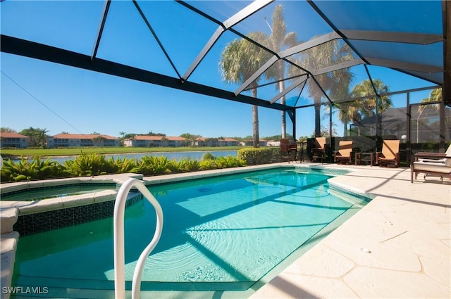 view of pool with glass enclosure, a pool with connected hot tub, a patio, and a water view