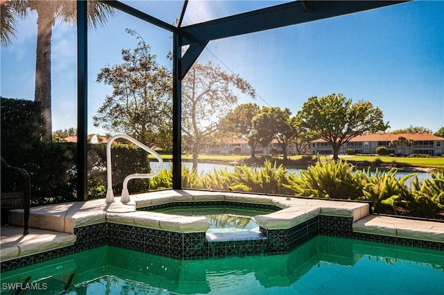 view of pool featuring a lanai and an in ground hot tub