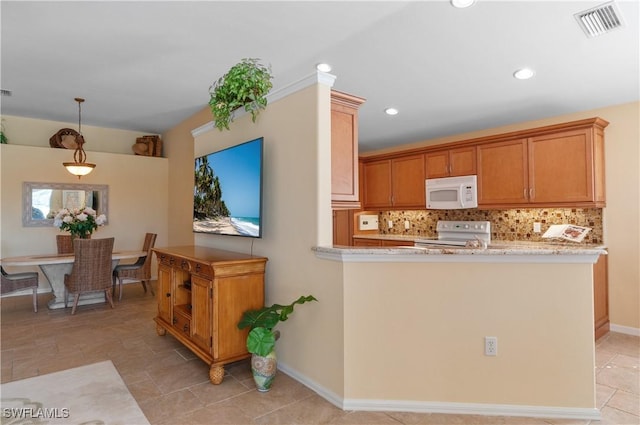 kitchen featuring white microwave, visible vents, electric range oven, decorative backsplash, and hanging light fixtures