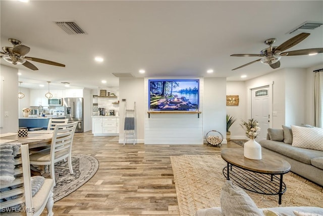618 SE 26th St, Cape Coral, FL 33904 - living room featuring a ceiling fan, recessed lighting, light wood finished floors, and baseboards